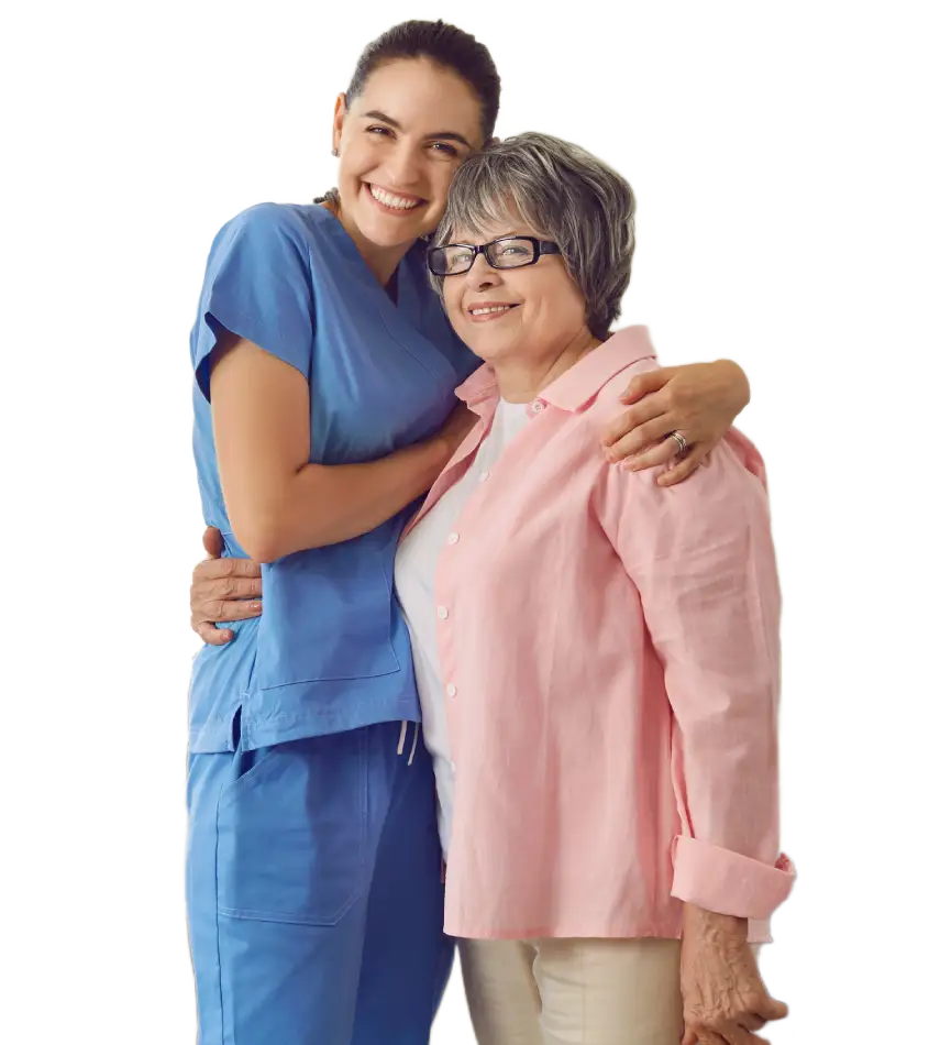 a younger caretaker standing with an older woman with her arm around her shoulder smiling